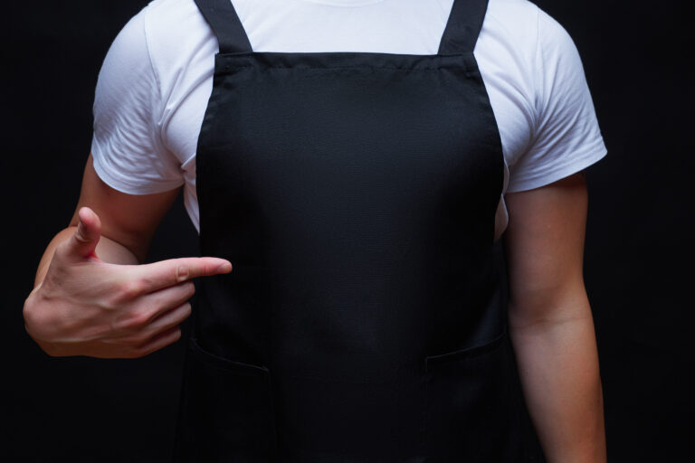 Strong,Guy,Torso,Wearing,Black,Apron,Showing,To,Apron,Center